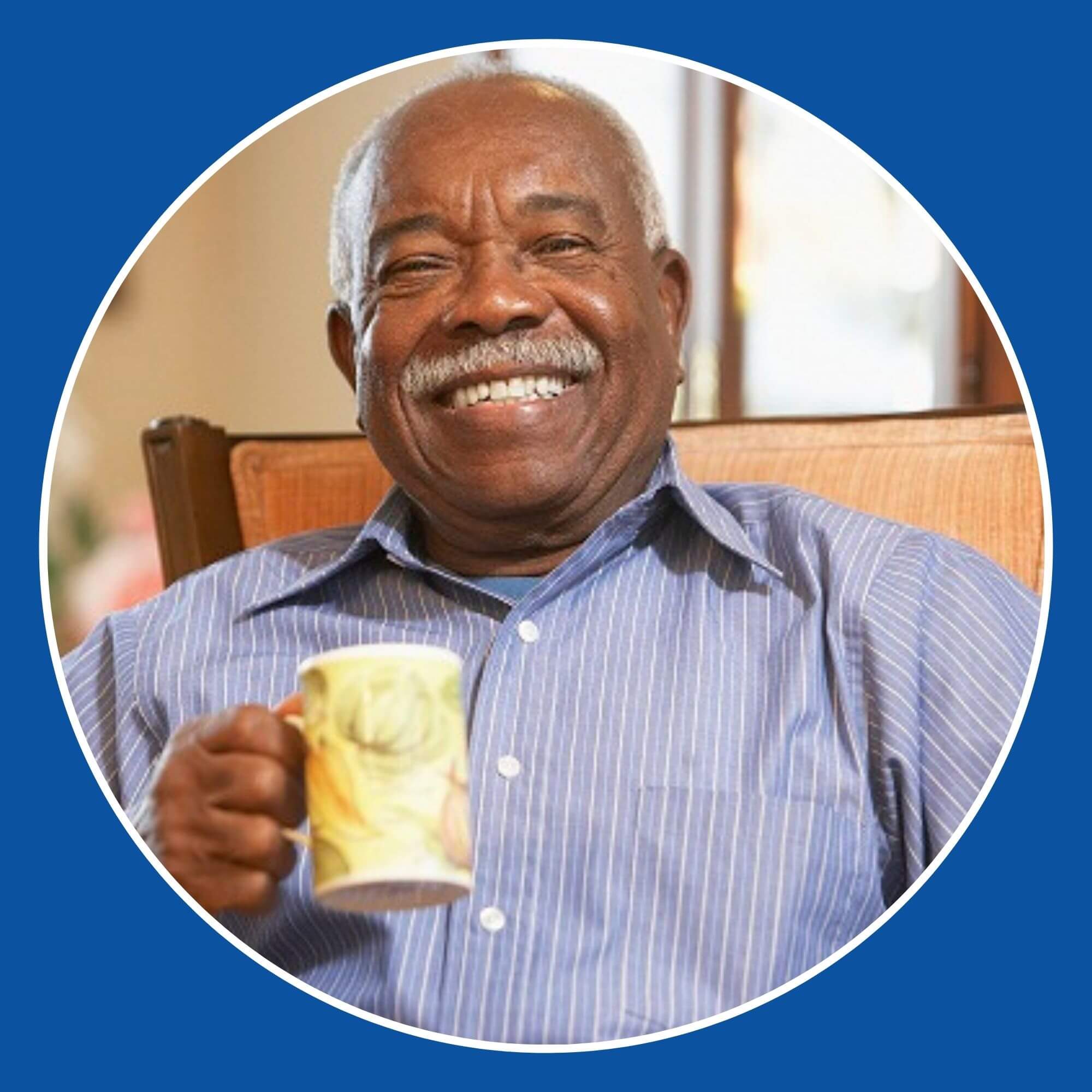 A happy elderly gentleman smiling in his chair
